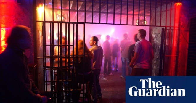 People standing in a dark nightclub