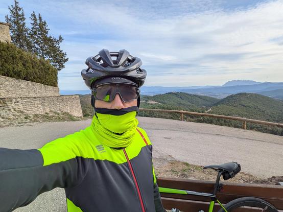 cyclist in winter gear with mountain in the background