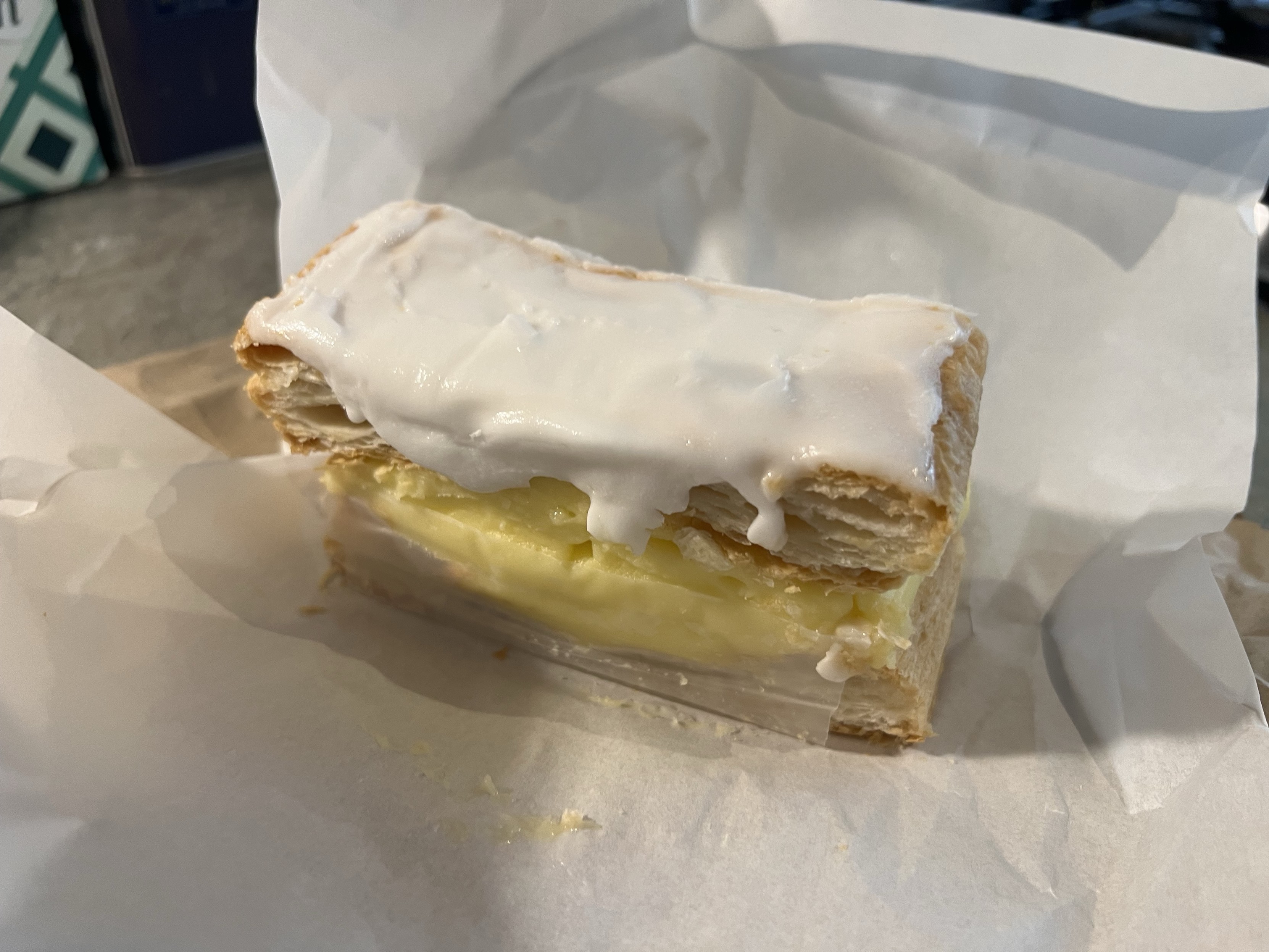 A vanilla slice filled with custard and topped with icing.