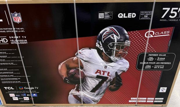 75” TCL flat screen tv box, with big image of an action shot Atlanta Falcon’s running back #7 in full Falcon’s kit (white jersey) carrying the football