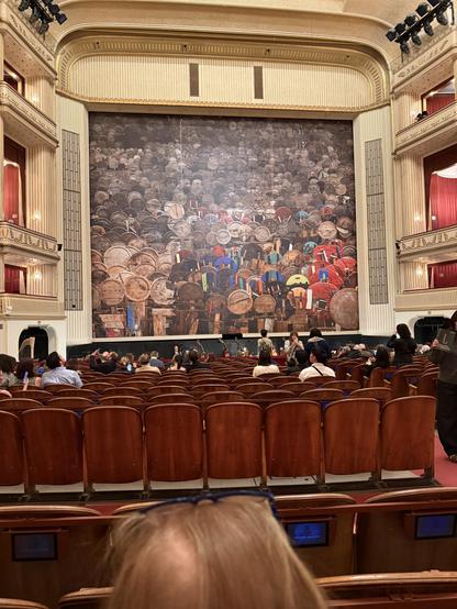 View of stage from our seats. Sparsely occupied seats in front of us.