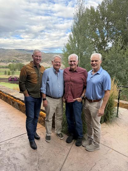 Four old white guys standing for photo with avail valley in the background.