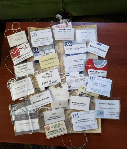 A whole bunch of name badges from various academic conferences.