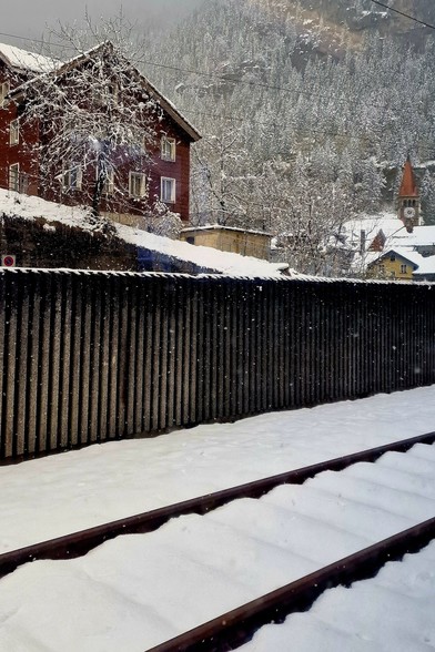 Tracks of Göschenen train station covered in fresh snow