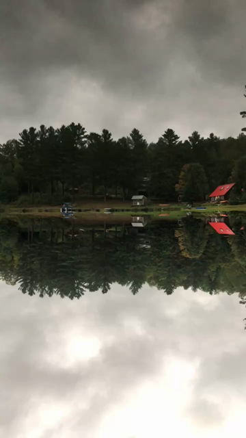 Slowly panning across a small still lake in Vermont. There are cabins and on the other side. The sky and the water are mirrored. The trick is that the panning reveals a canoe on the lake, but it’s in the “sky”; the video was upside down the whole time.