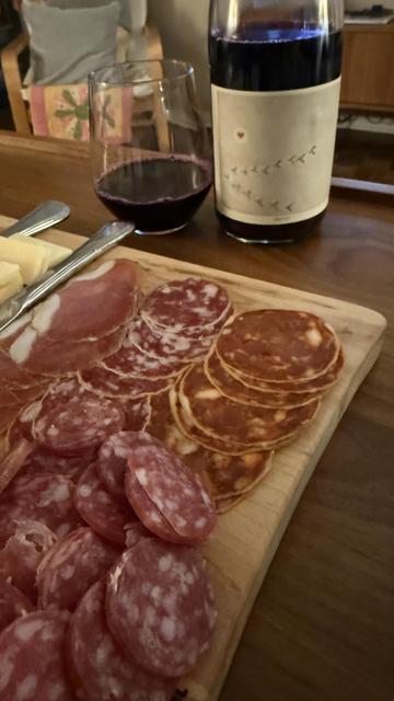 Front label, poured glass, and charcuterie dinner.