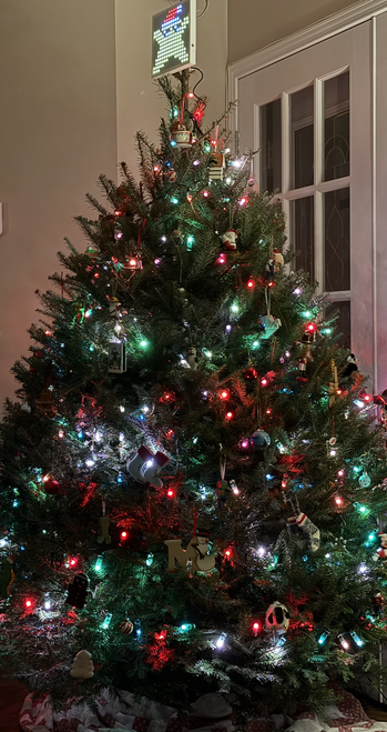 A lit and decorated Christmas tree, with a “star” tree topper (a 16x16 customizable panel; that’s the Swift-powered part).