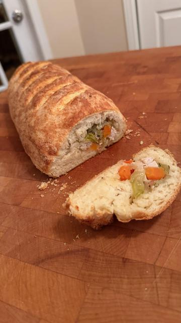 The cooked turkey roll as described above, with one sliced piece.