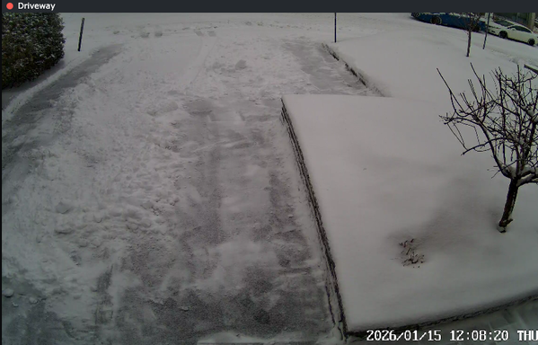 The driveway, with snow cleared from the edges so the plow can actually remove it.