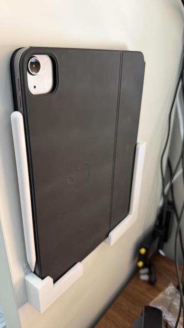 iPad in its case mounted on the shelf exterior next to where I sit.