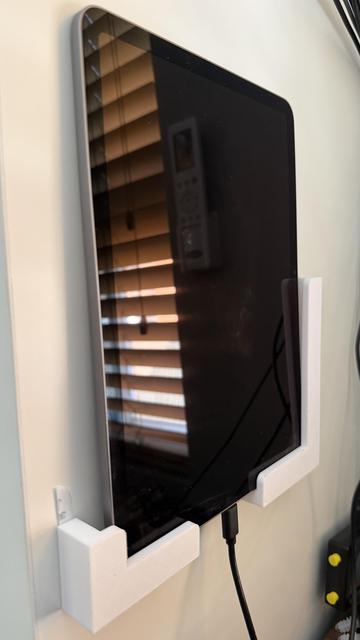 iPad on the same mount, without its case and plugged in to charge.