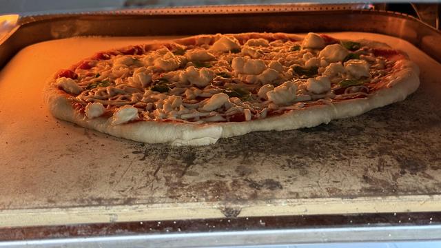 A cooking pizza right after launch.