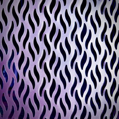 Thick, wavy holes repeat in a tiled pattern within a slightly purple, metallic wall, filling the entire frame.