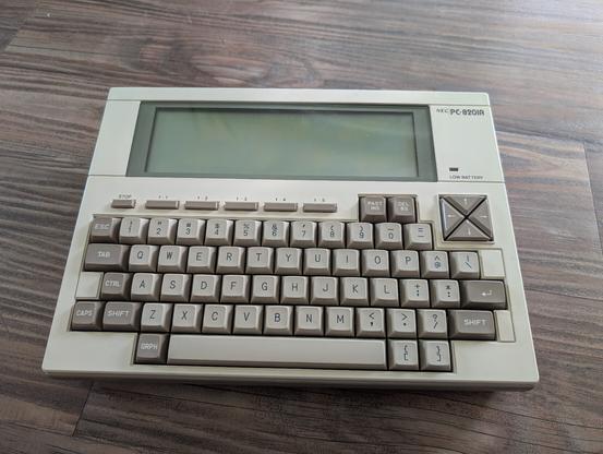 My lovely NEC PC-8201a, a slabtop from the early 80s, rests on the floor.