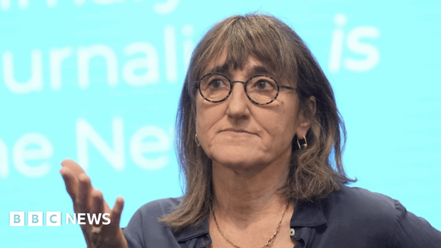 Baroness Kidron wears a grey t-shirt and tortoiseshell glasses