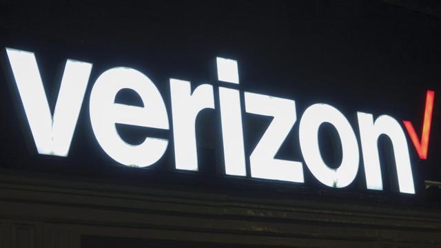 A Verizon logo displayed on the outside of a store. A Verizon logo displayed on the outside of a store.