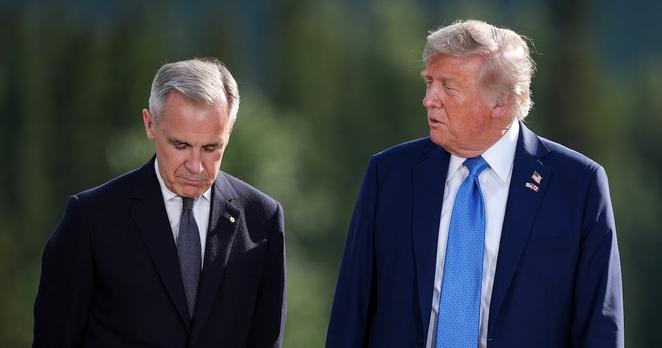 Prime Minister Mark Carney, left, listens to U.S. President Donald Trump while posing for the family photograph during the G7 Summit in Kananaskis, Alta., Monday, June 16, 2025. THE CANADIAN PRESS/Darryl Dyck