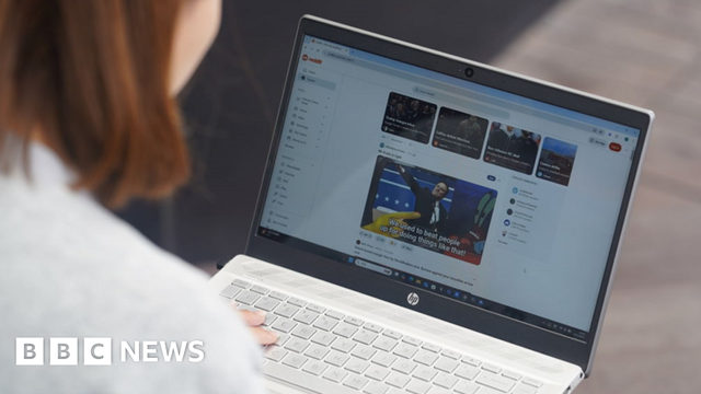 Woman looks at Reddit website on a laptop