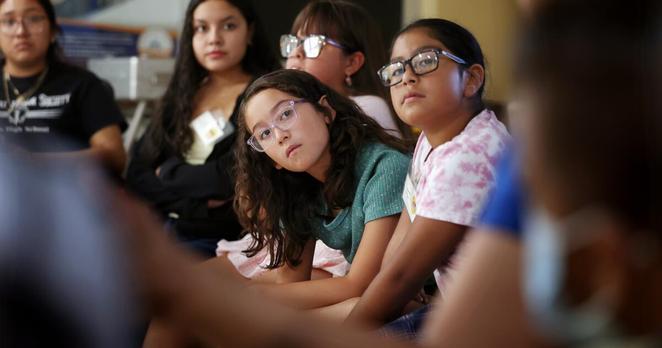 PERRIS, CA, JULY 11, 2025: Children join a conversation about their love for their families and their fears about ICE being in their community with Executive Director Luz Gallegos, at right, while attending "Monarcas Luchadoras," a youth leadership and development program, at TODEC Legal Center in Perris, California on Friday, July 11, 2025. Gallegos' parents, who were farm workers and organizers, founded TODEC in the early 1980s. (Christina House / Los Angeles Times) PERRIS, CA, JULY 11, 2025: Children join a conversation about their love for their families and their fears about ICE being in their community with Executive Director Luz Gallegos, at right, while attending "Monarcas Luchadoras," a youth leadership and development program, at TODEC Legal Center in Perris, California on Friday, July 11, 2025. Gallegos' parents, who were farm workers and organizers, founded TODEC in the early 1980s. (Christina House / Los Angeles Times)
