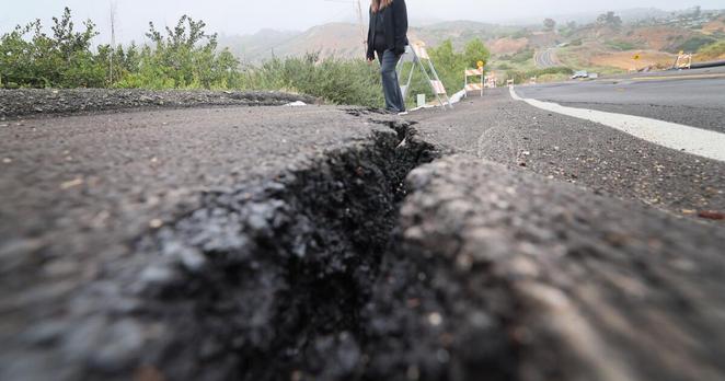 Rancho Palos Verdes, CA - June 04: Eva Albuja, a longtime resident of Rancho Palos Verdes views the landslide zone damage on Palos Verdes Drive South in the Portuguese Bend area near her home Wednesday, June 4, 2025. Albuja has been living without natural gas service for months, but is hopeful it will be turned on soon. She's been surviving at home without hot water, her stove, etc, and views the latest in the landslide movement in her neighborhood in the Portuguese Bend area (where movement is still bad and her parents live). (Allen J. Schaben / Los Angeles Times)