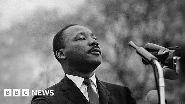 Martin Luther King Jr photographed speaking before a massive crowd in Alabama