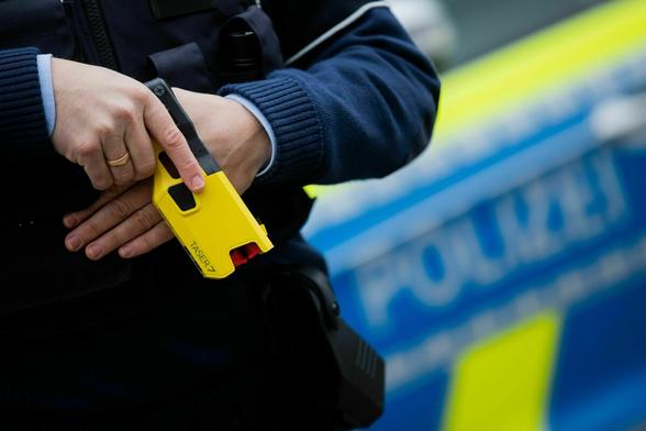 Polizist hält seinen Teaser bereit