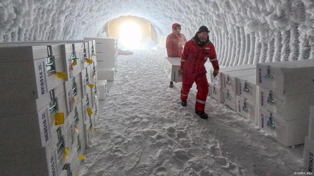 Two scientist in an ice cave storing ice samples