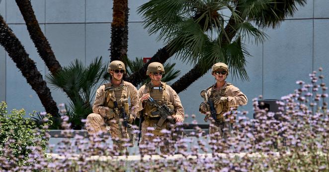 Marines guard a federal building in Los Angeles as people protest the Trump administration’s immigration raids in June. 