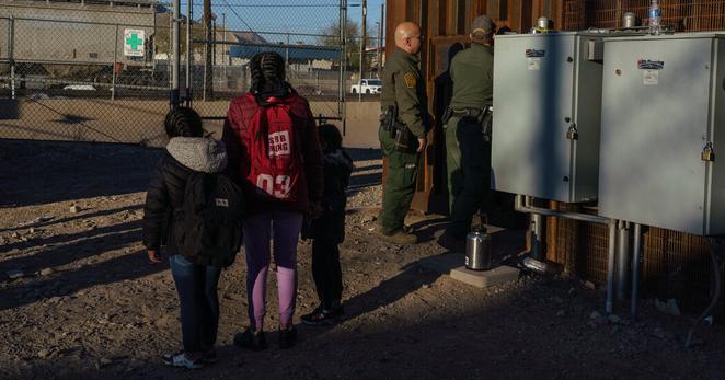 Unaccompanied minors wait for U.S. Border Patrol agents after being allowed in at El Paso, Texas.