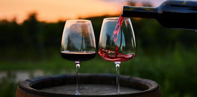 Two glasses of red wine being poured. | Rostislav_Sedlacek/Shutterstock