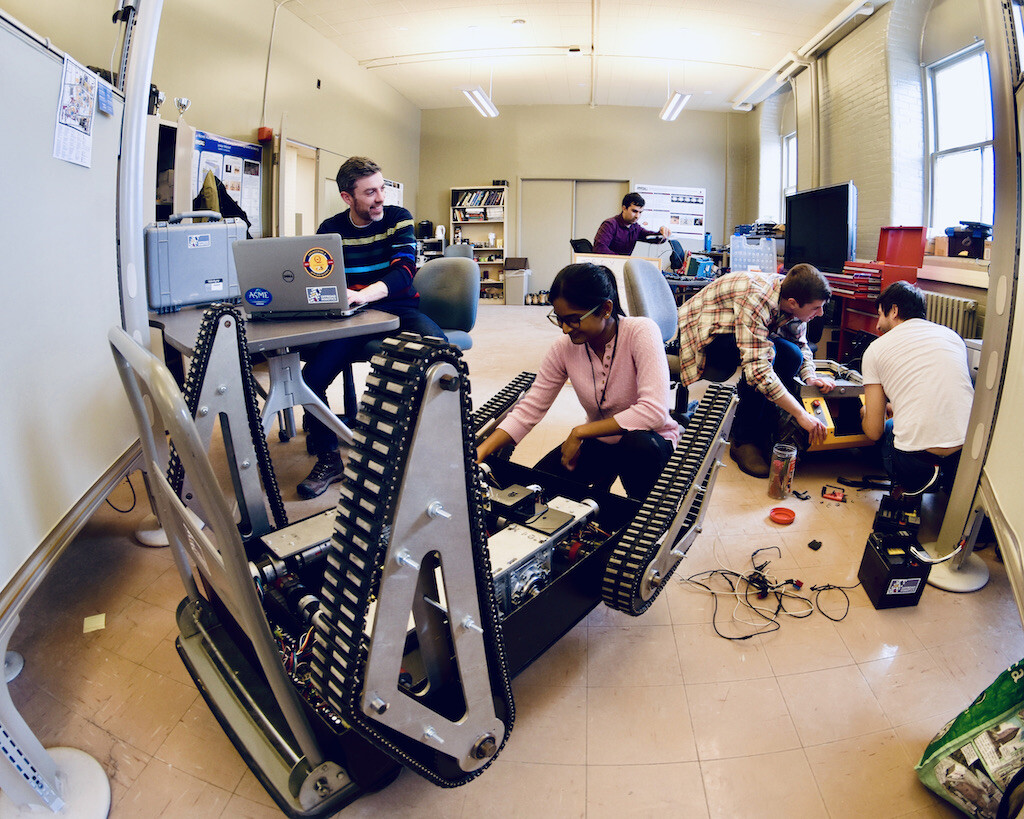 Some of my #research team and me working on mobile #robots at Queen's U.  — Photo credit: Dr. Heshan Fernando