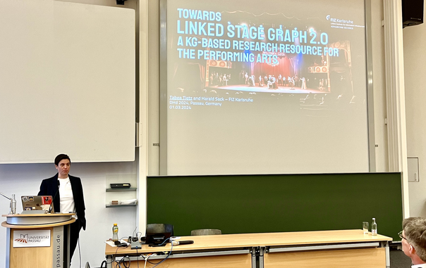 Tabea Tietz from FIZ Karlsruhe presenting Towards Linked Stage Graph 2.0 on stage at DHd2024 in Passau.