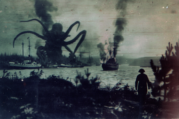 A gigantic tentacular horror threatens several sailing ships on a wide river or bay. Another is already burning