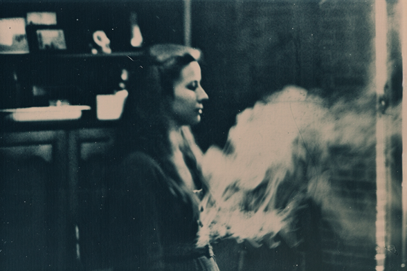 A woman in a trance, with ectoplasm forming a shape in front of her