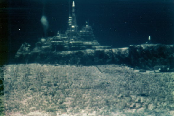 Distant view of the ruins of an ancient city at the bottom of the ocean, with slender spires and bulbous domes