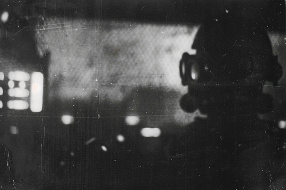 Profile view of a soldier in gas protection gear in an unidentifiable location