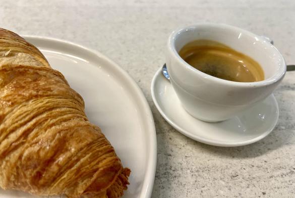 Espresso with croissant on a white table. Cafe MoLa, Frankfurt am Main