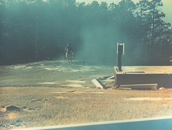 Humanoid walking in a misty outdoor area with a concrete platform in the foreground.