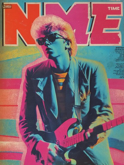 The image showcases a stylised poster of a person playing an electric guitar. The person is depicted in a vibrant, high-contrast colour scheme with blue skin tones and pink highlights. They are wearing a dark suit with a striped shirt underneath, and sunglasses. The background is a mix of bright blue and pink with textured patterns. At the top, large red letters "NME" are prominently displayed, accompanied by the smaller text "TIME" in white. The overall composition has a retro and dynamic aesthetic.