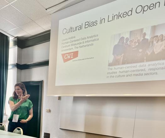 Laura Hollink presenting her keynote at Semantic Digital Humanities 2025 Workshop, standing in front of the projection screen.