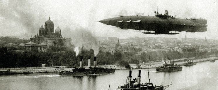A large airship flies over a city with steamships on a river below.