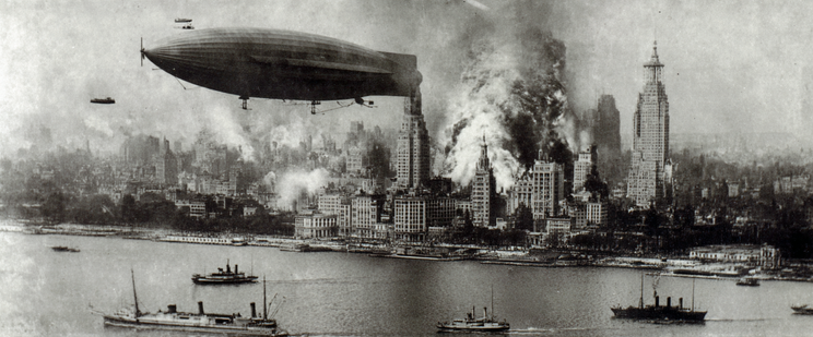 A large airship over a cityscape with buildings and smoke, and boats in the foreground.