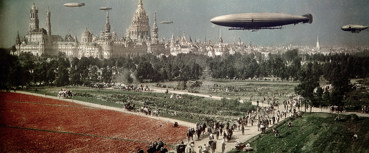 Cityscape with Gothic architecture and airships overhead.