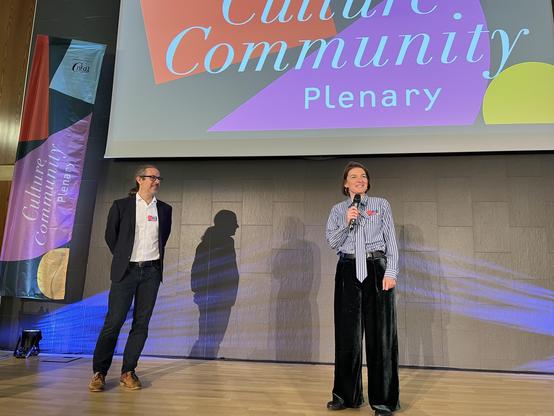 Torsten (Left) and Sarah (Right) standing on the stage in front of the large presentation screen during the opening of the CCP