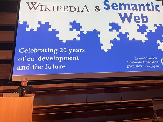 Denny Vrandencic in front of the projection of the opening slide of his iswc2025 keynote 