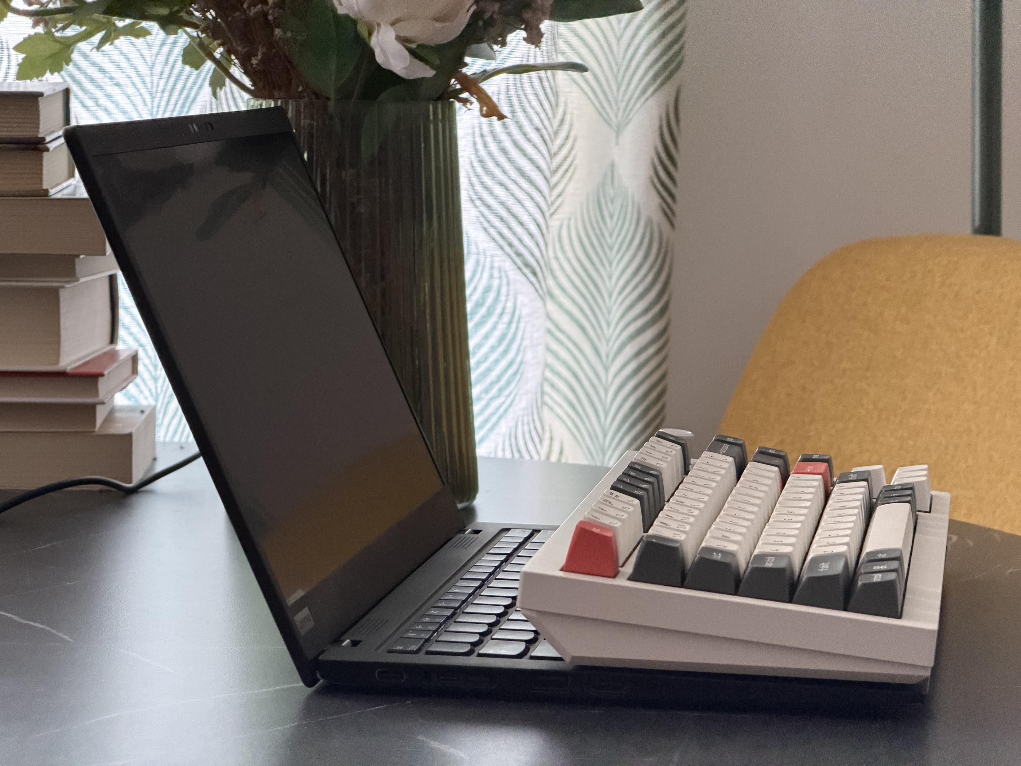 Mechanical keyboard sitting on top of thin ultrabook