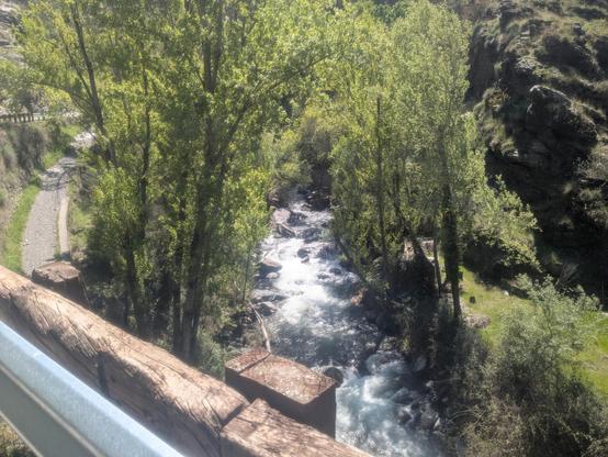 A mountain stream down below seen from the road