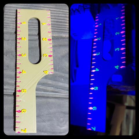 Wargaming measuring tool - simple ruler which measures 7 inches across one side, 4 across the other and is 2 wide. It is accurate to a quarter inch.

In een flash of brilliance I decided to not just ink the recessed scale lines, but also put Magenta Fluo paint in them, and then of course I could not NOT paint the numbers yellow