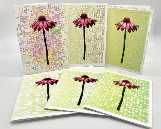 Product photo of six greeting cards featuring illustrated pink daisies against green graphic background patterns.