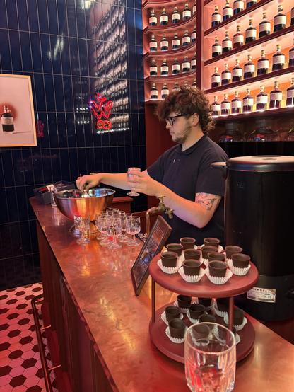 Barman pouring cherry vodka.